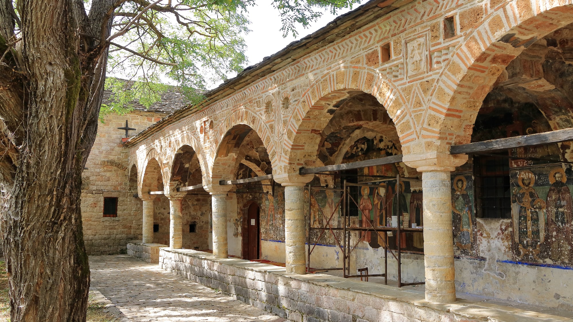 a stone building with a stone wall and a stone walkway