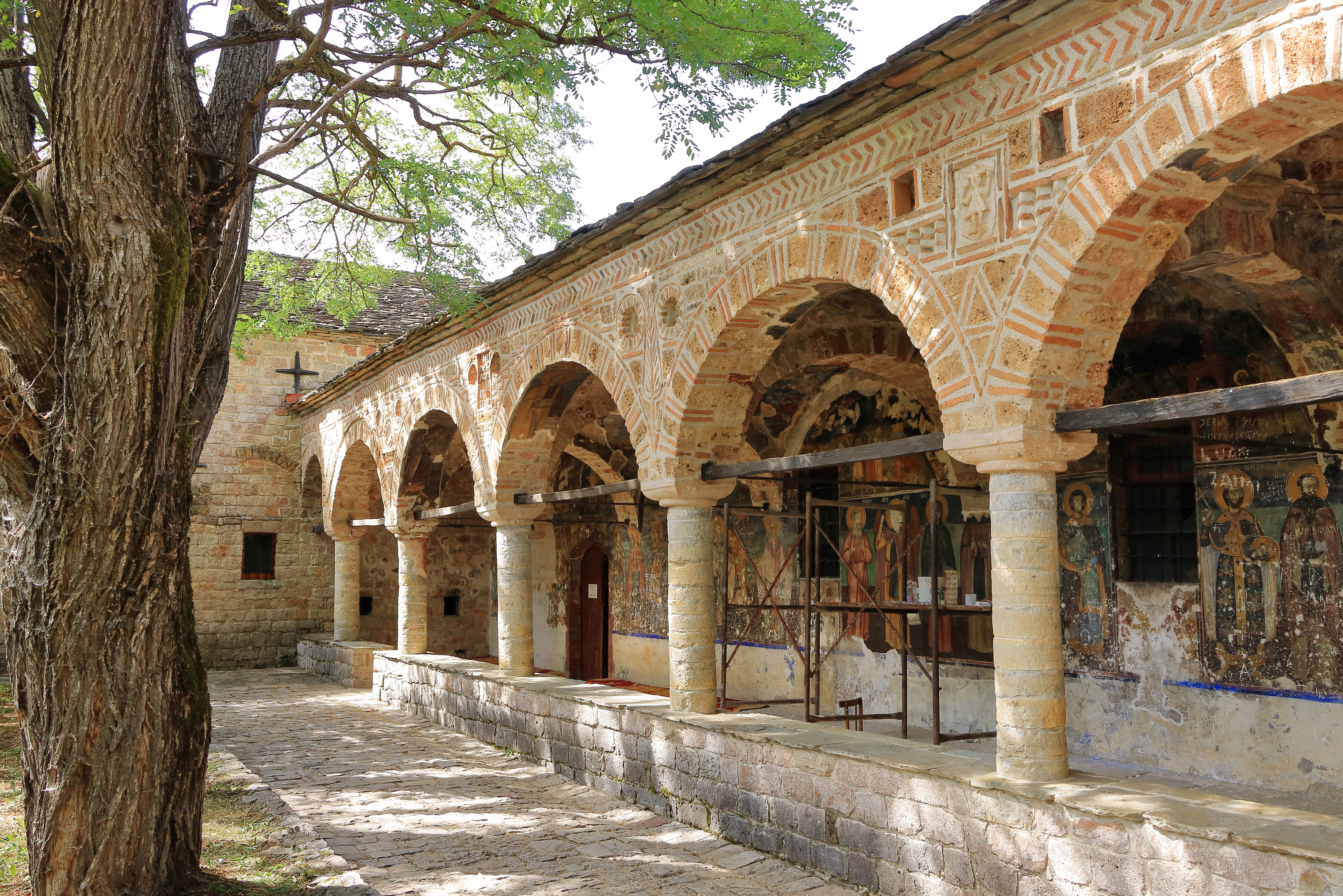 a stone building with a stone wall and a stone walkway