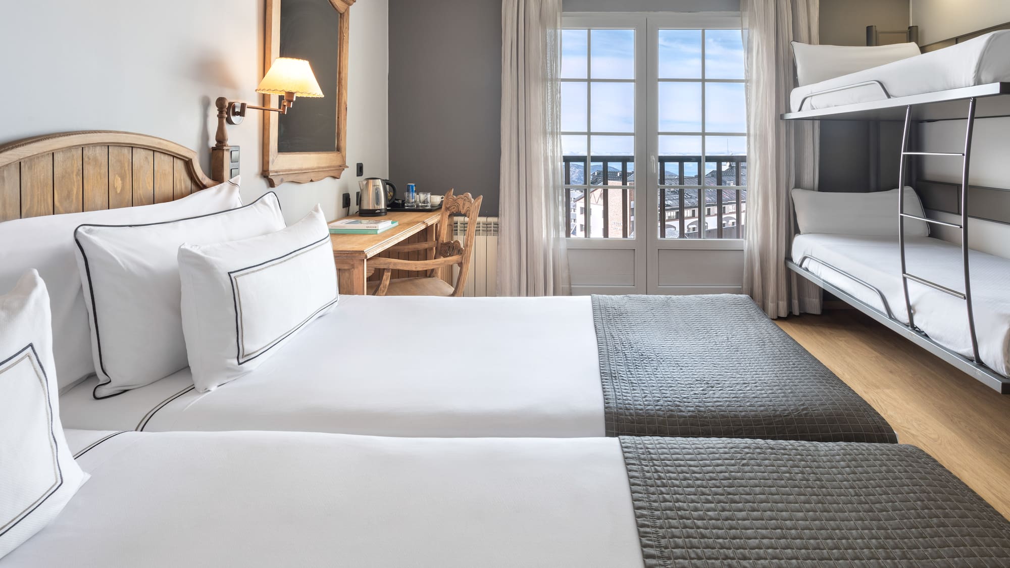 a room with two beds and a desk