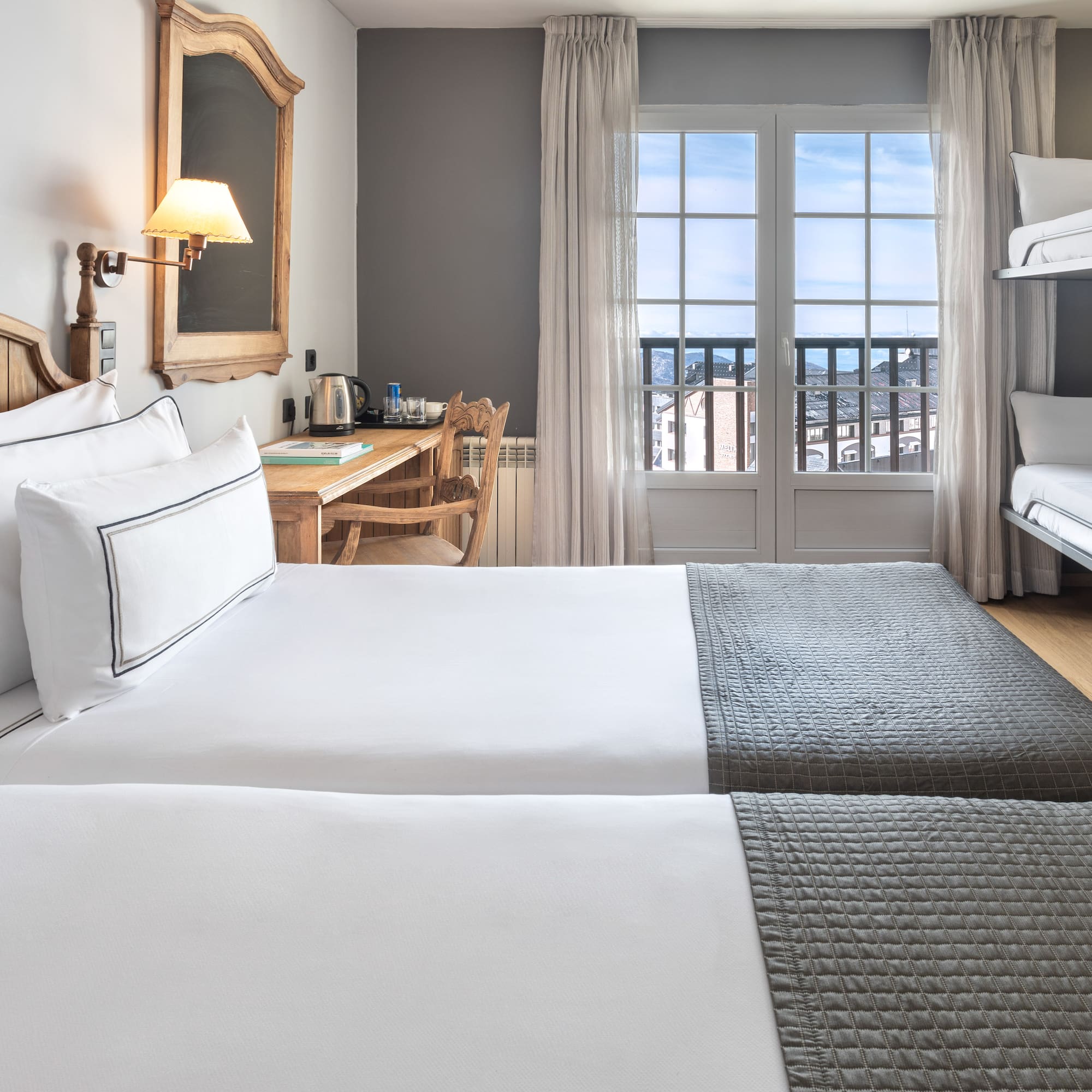 a room with two beds and a desk