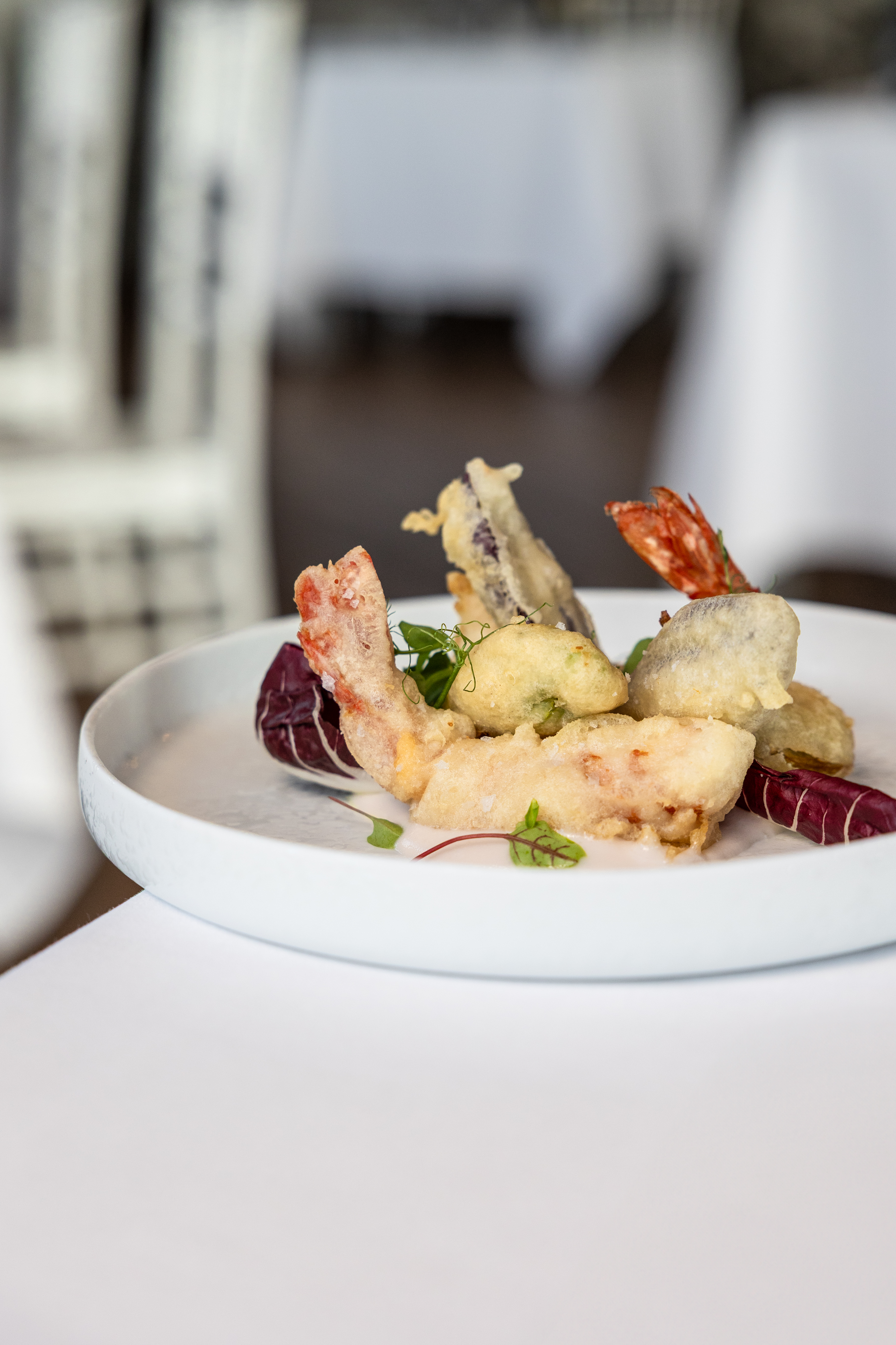 Gourmet tempura fried shrimp and mixed vegetables with radicchio.