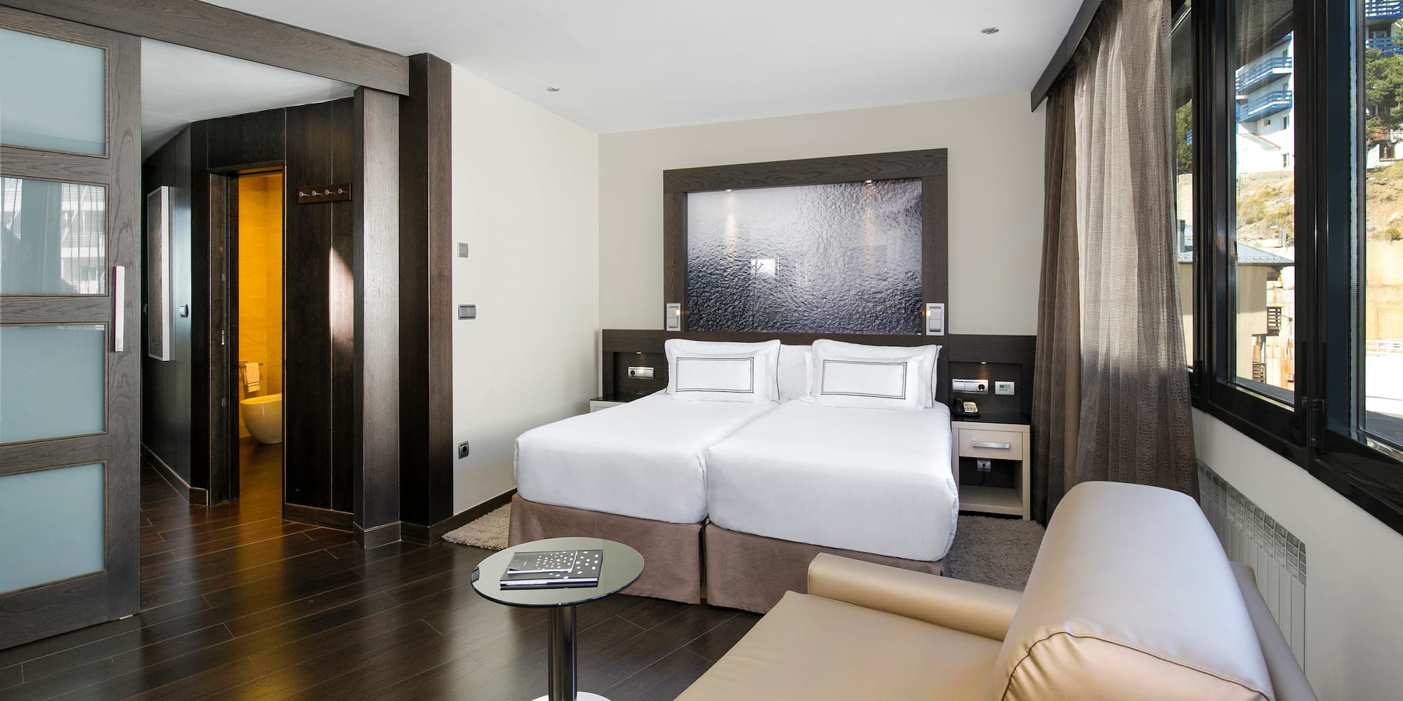 a room with two beds and a table
