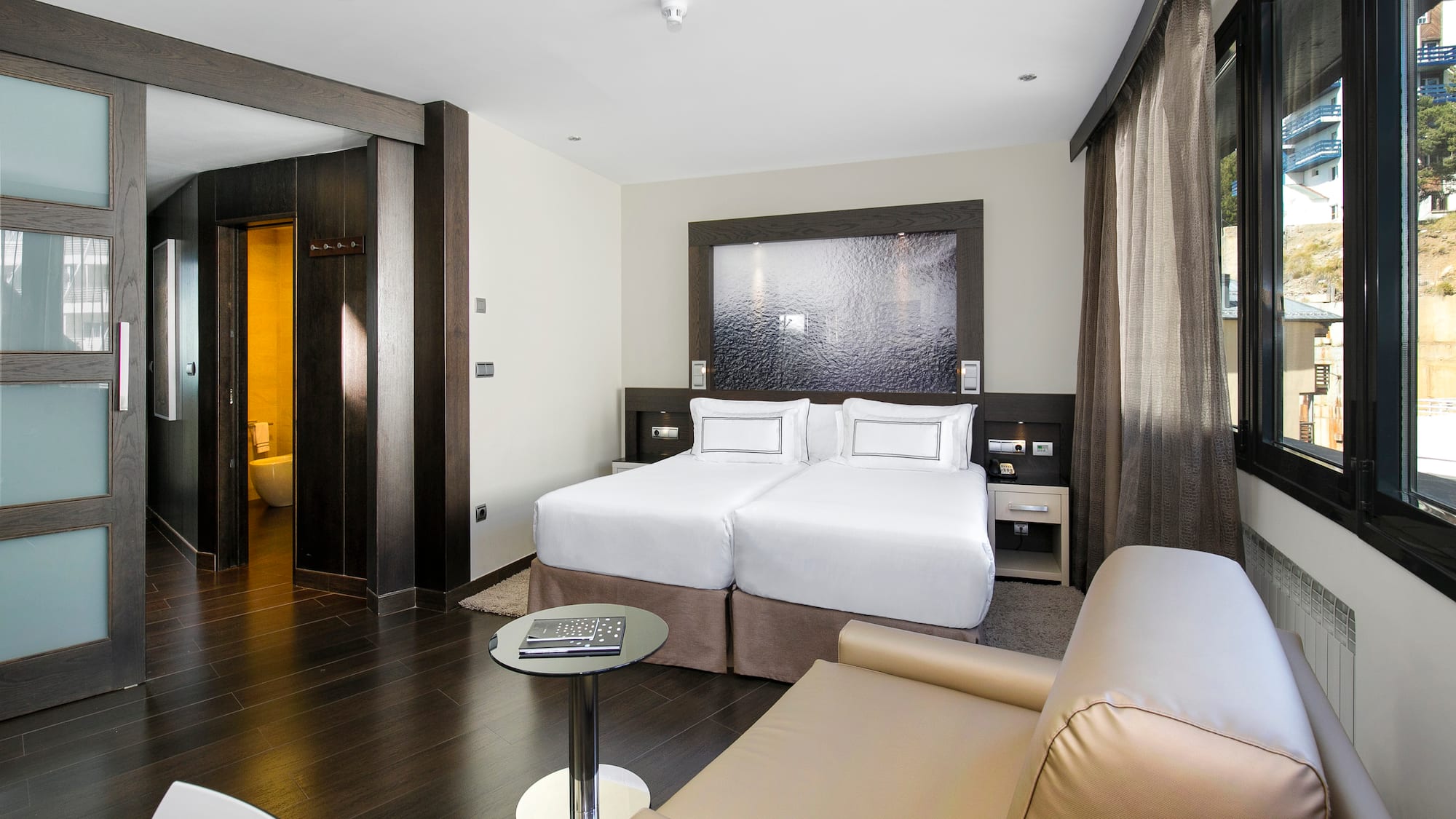 a room with two beds and a table