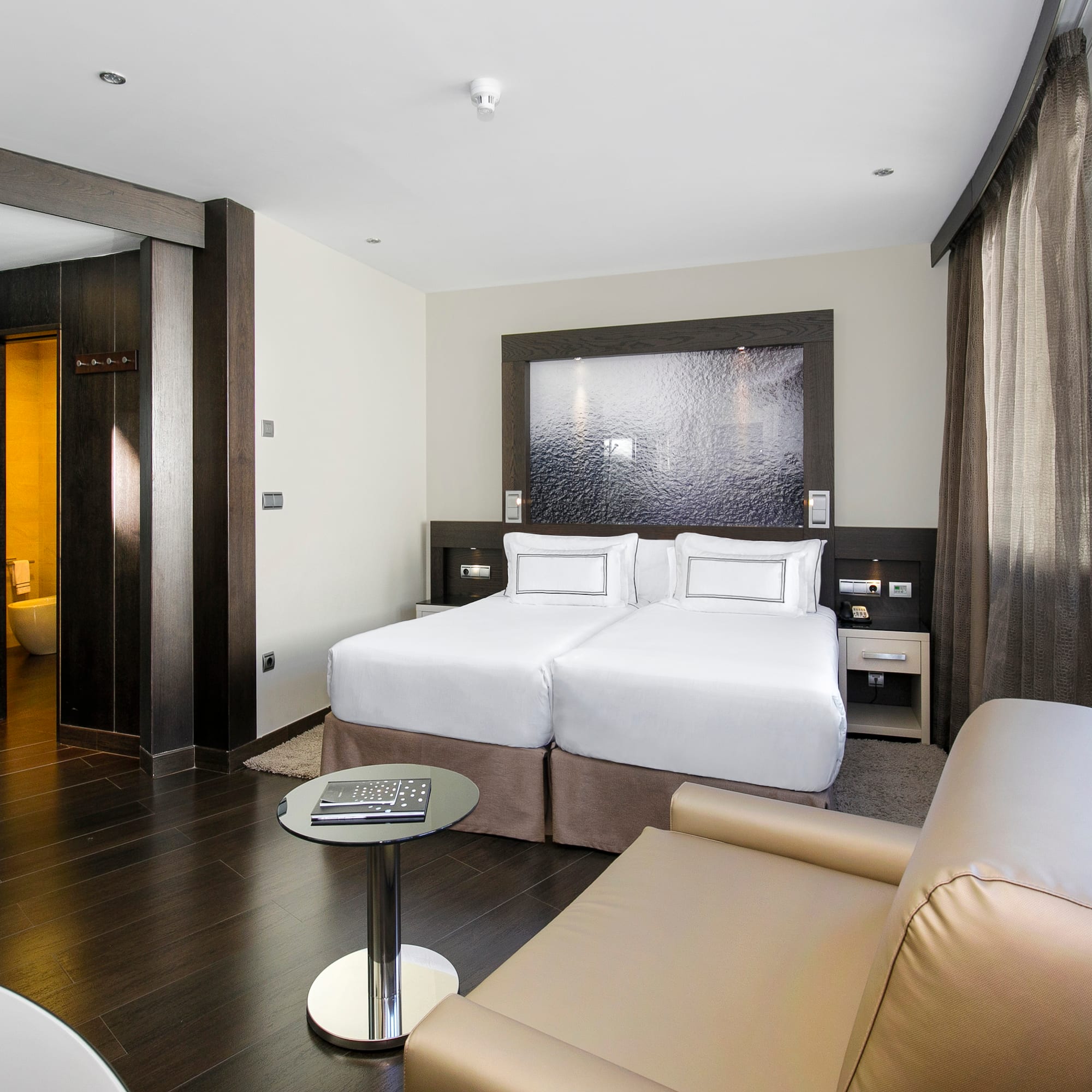 a room with two beds and a table