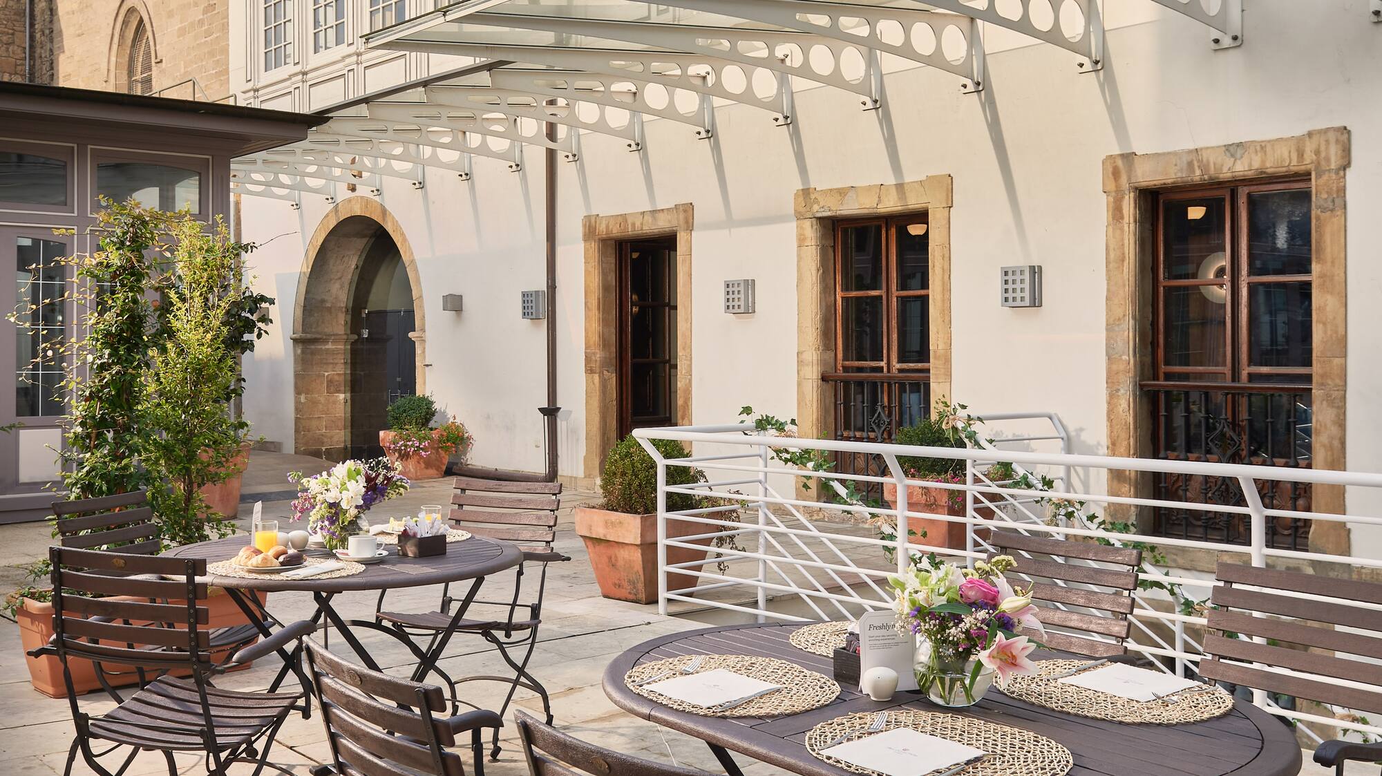 a patio with tables and chairs