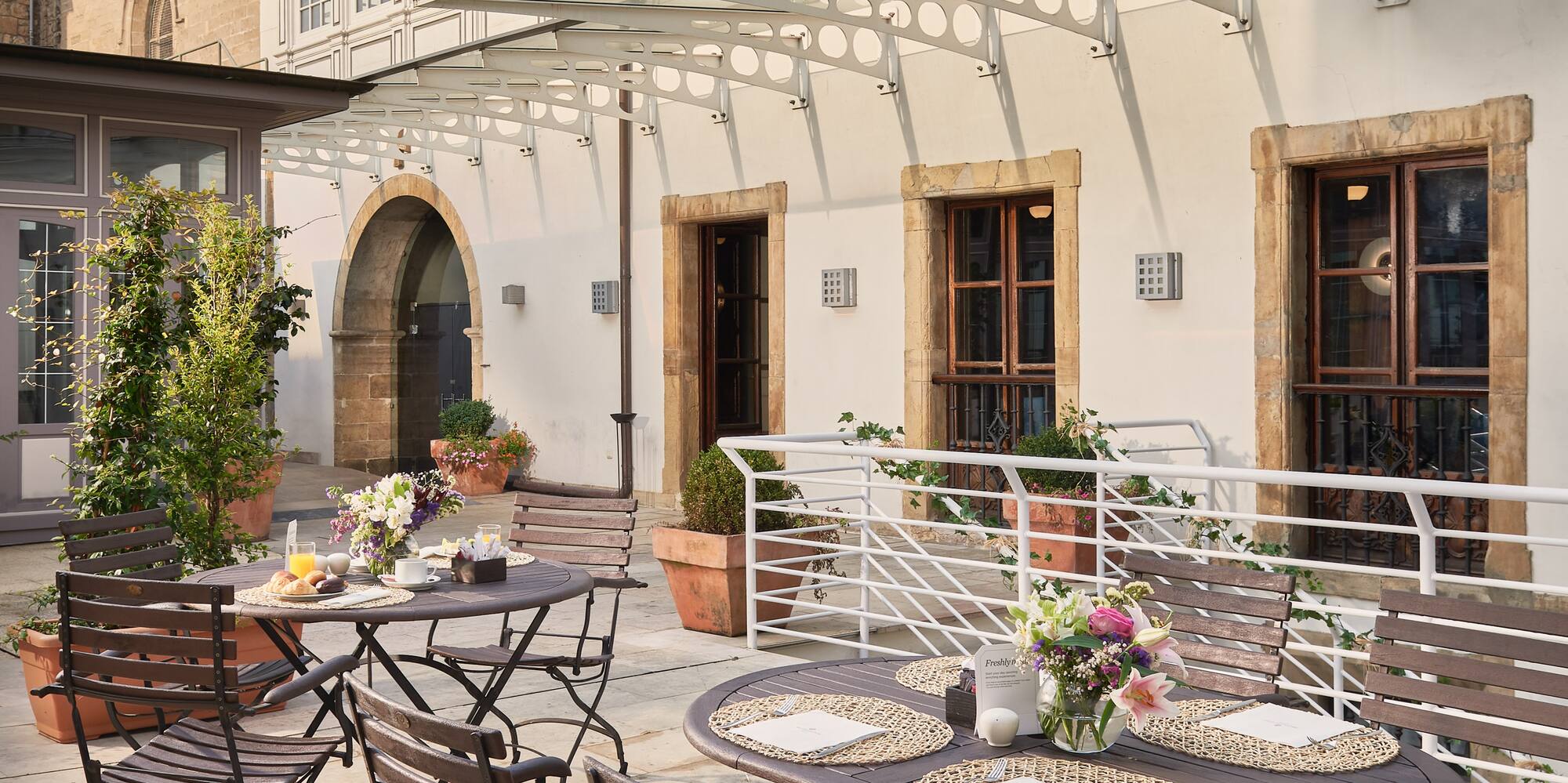 a patio with tables and chairs