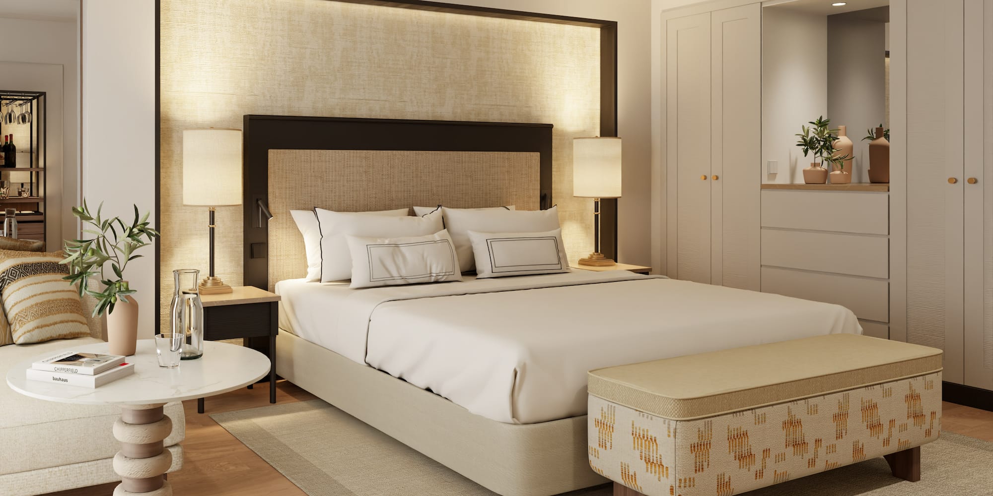 a bed with a headboard and a table with lamps