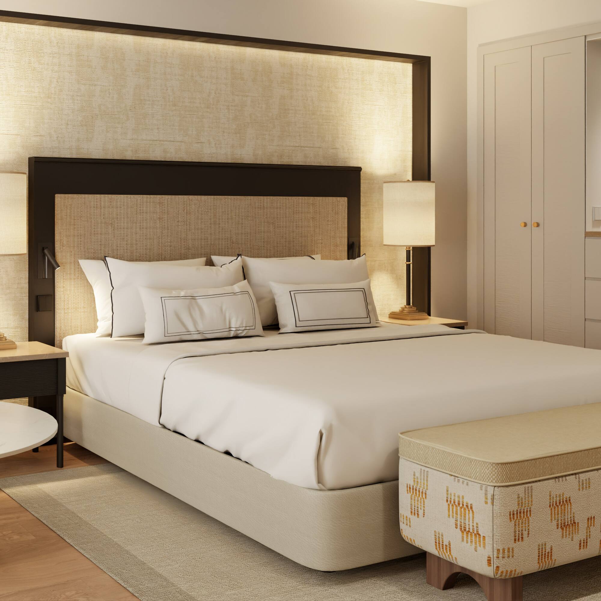 a bed with a headboard and a table with lamps