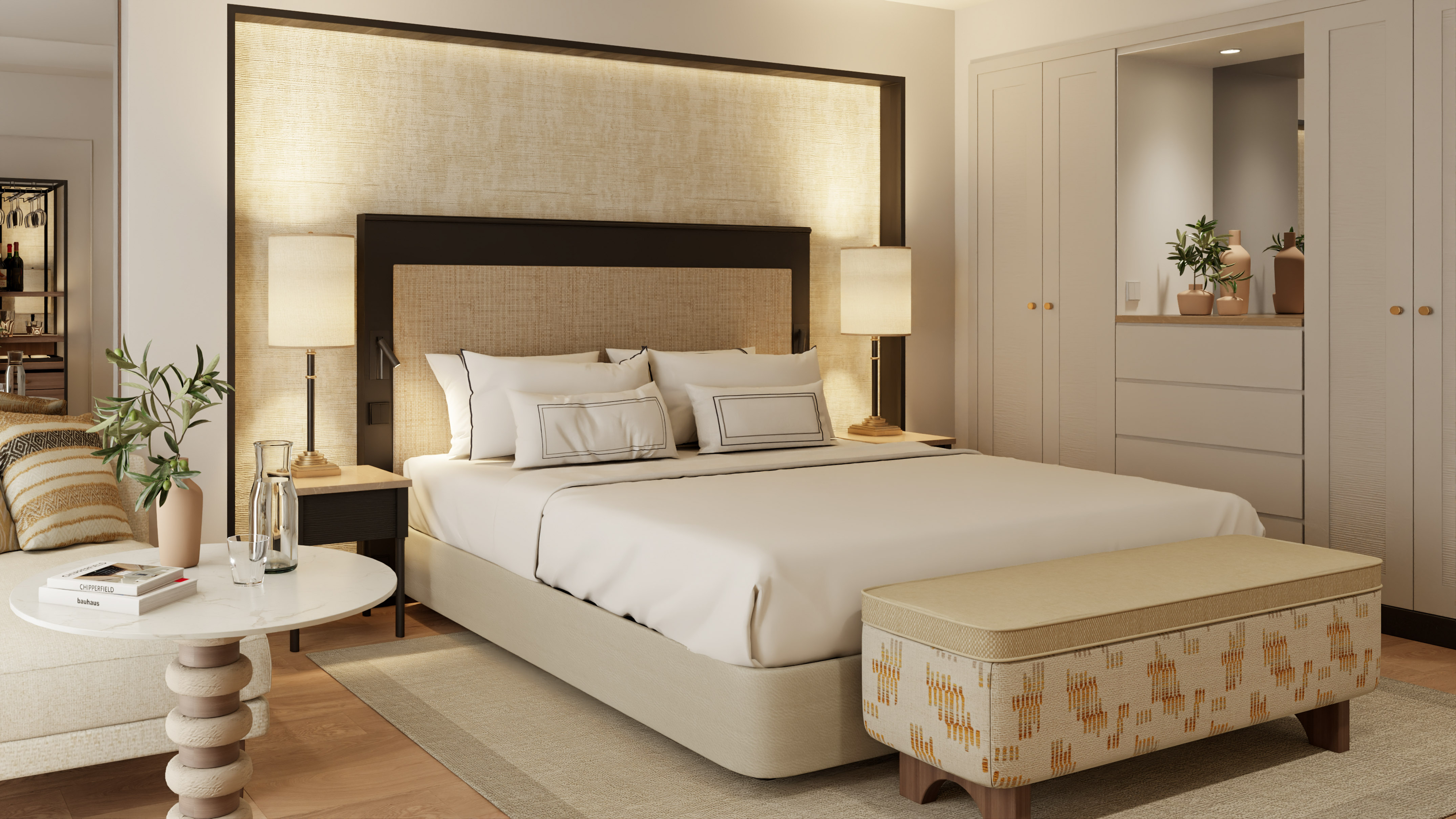 a bed with a headboard and a table with lamps