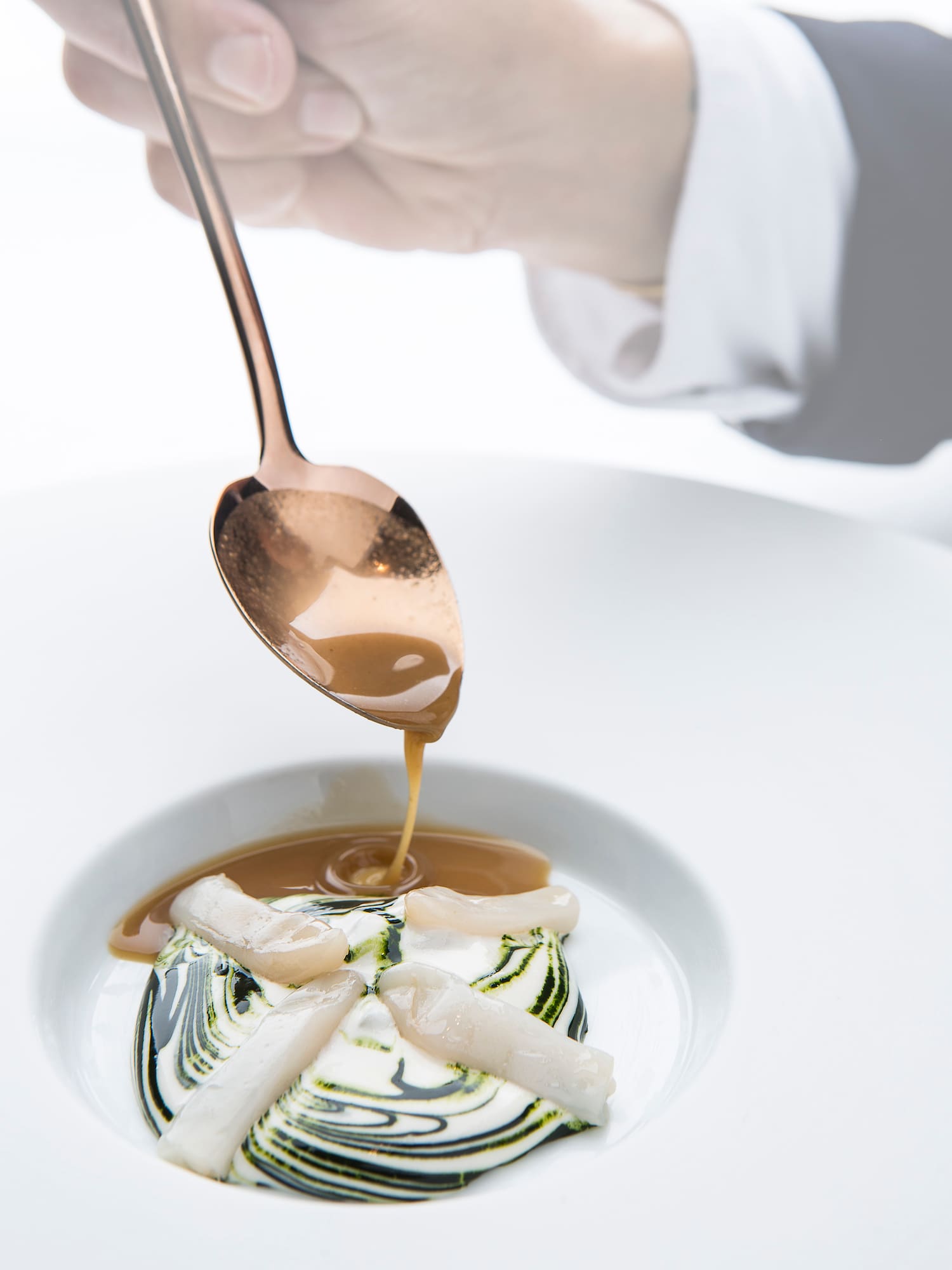 a spoon over a dessert