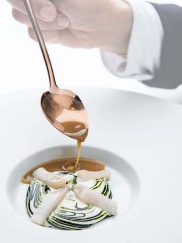 a spoon over a dessert