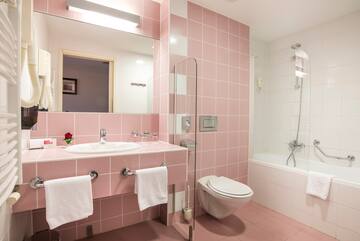 a bathroom with pink tiles