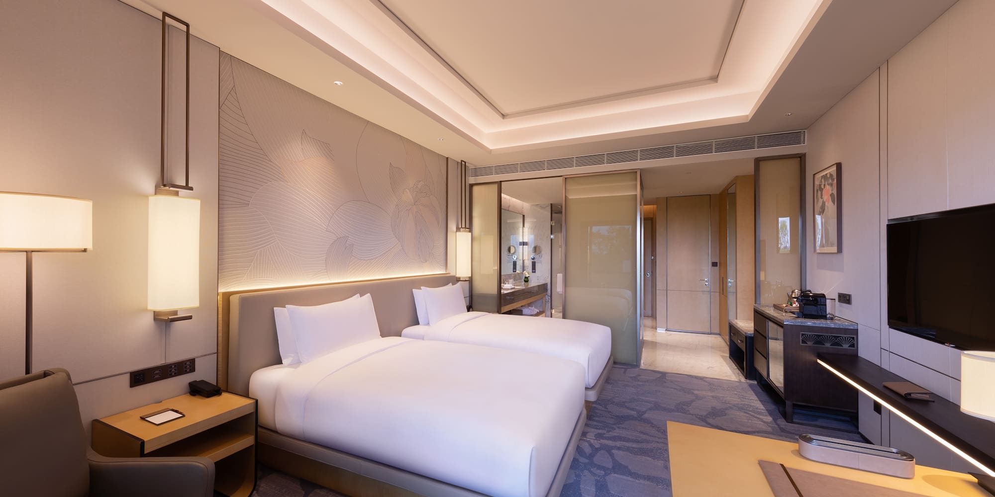 a room with two beds and a table