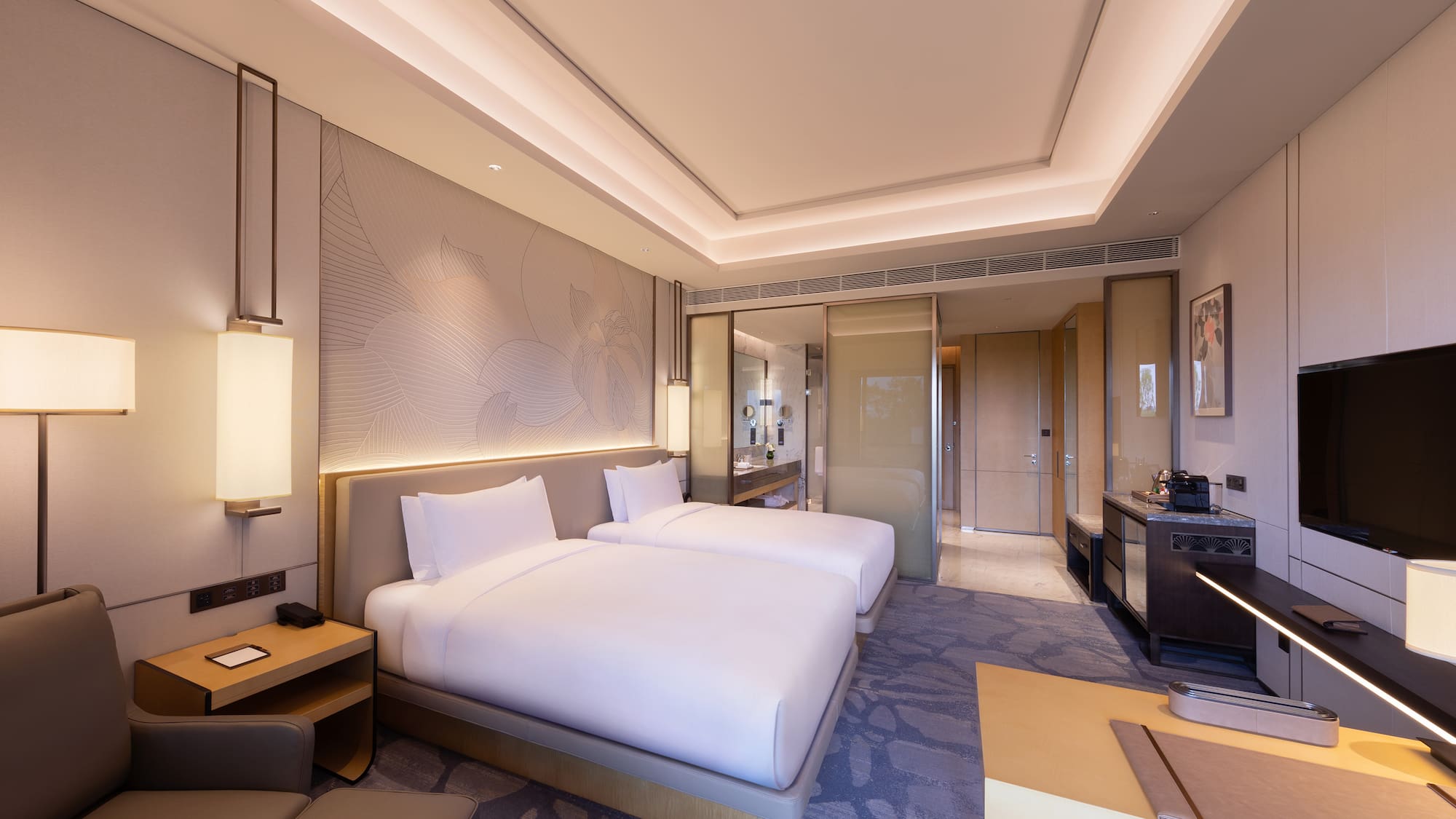 a room with two beds and a table