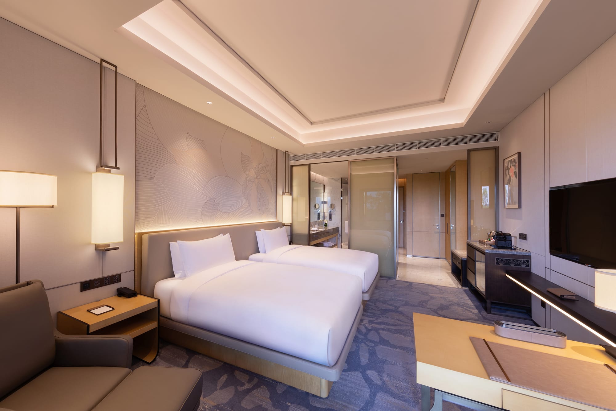 a room with two beds and a table