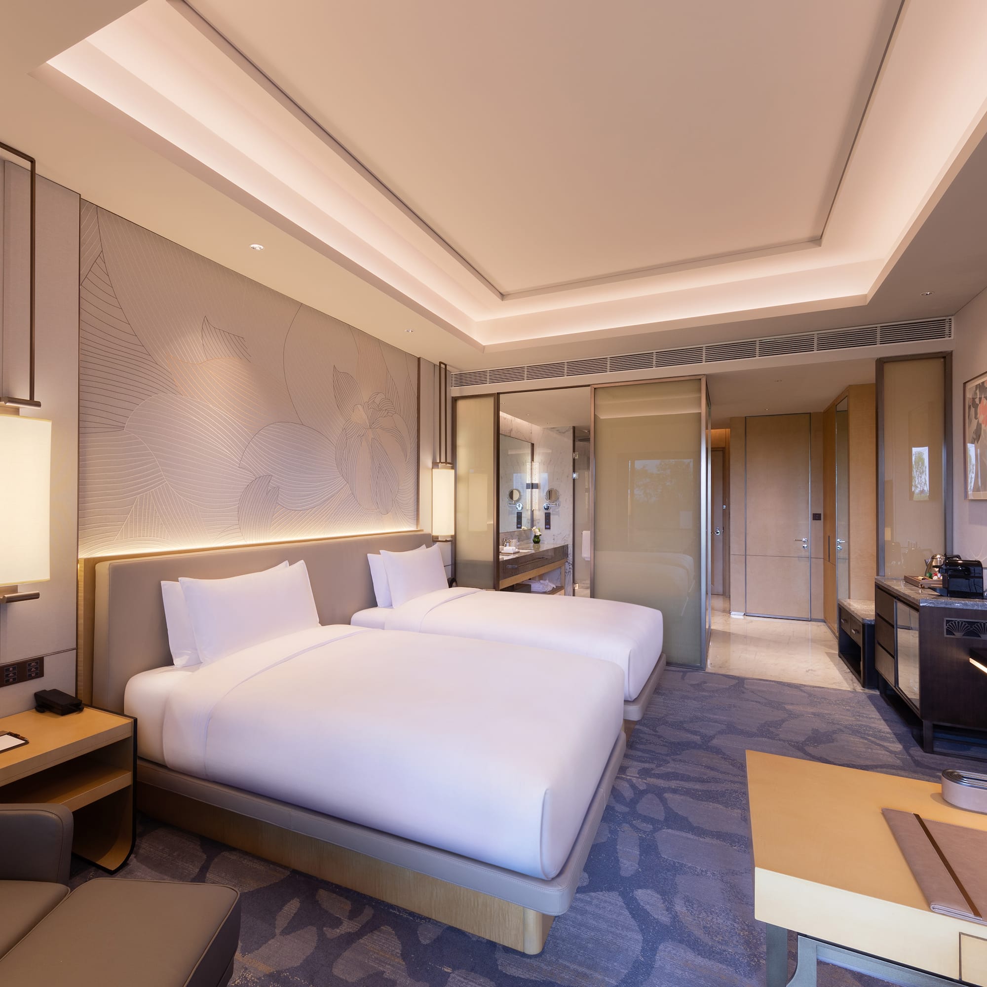 a room with two beds and a table