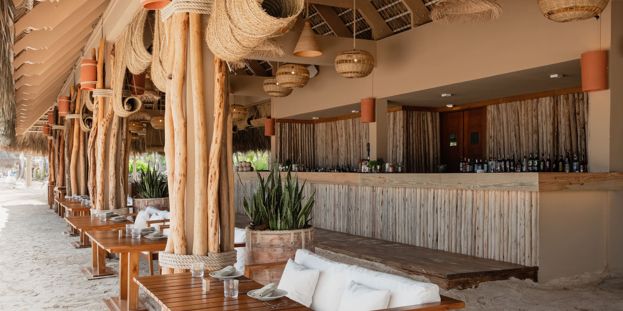 a room with a bar and tables