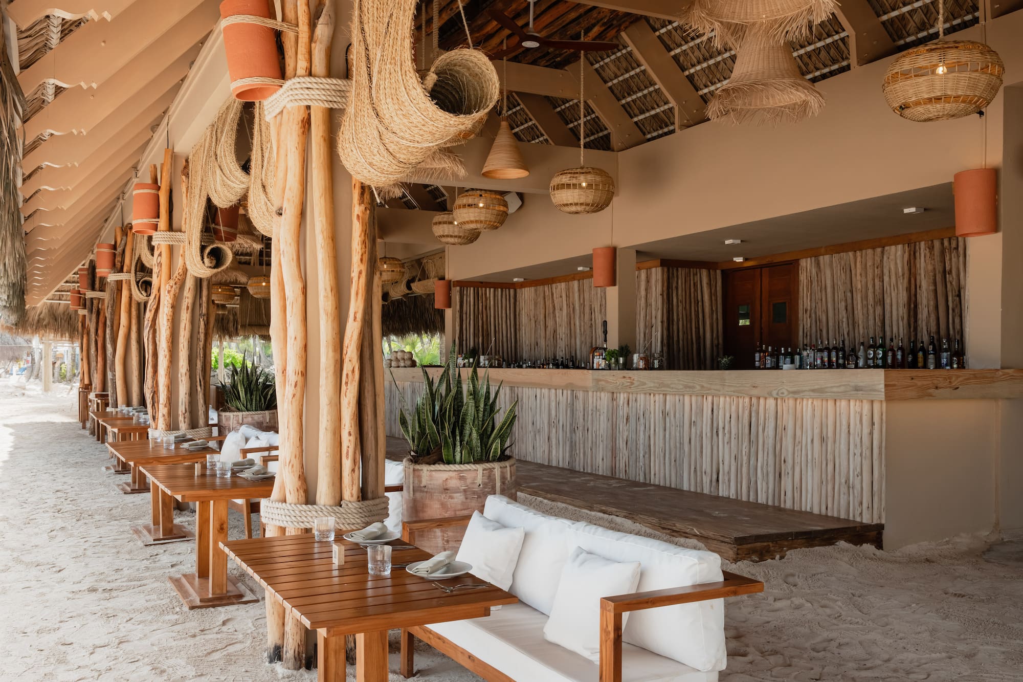 a room with a bar and tables