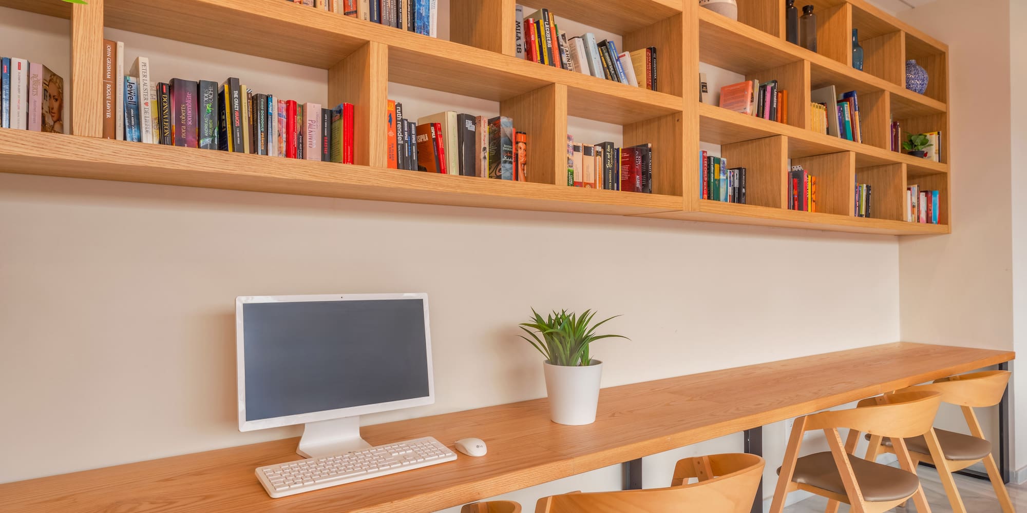 a desk with a computer and books on it