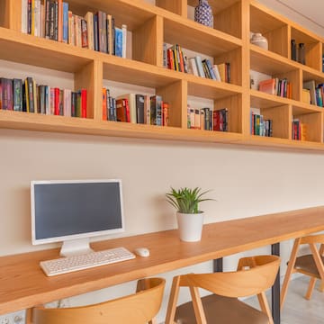a desk with a computer and books on it