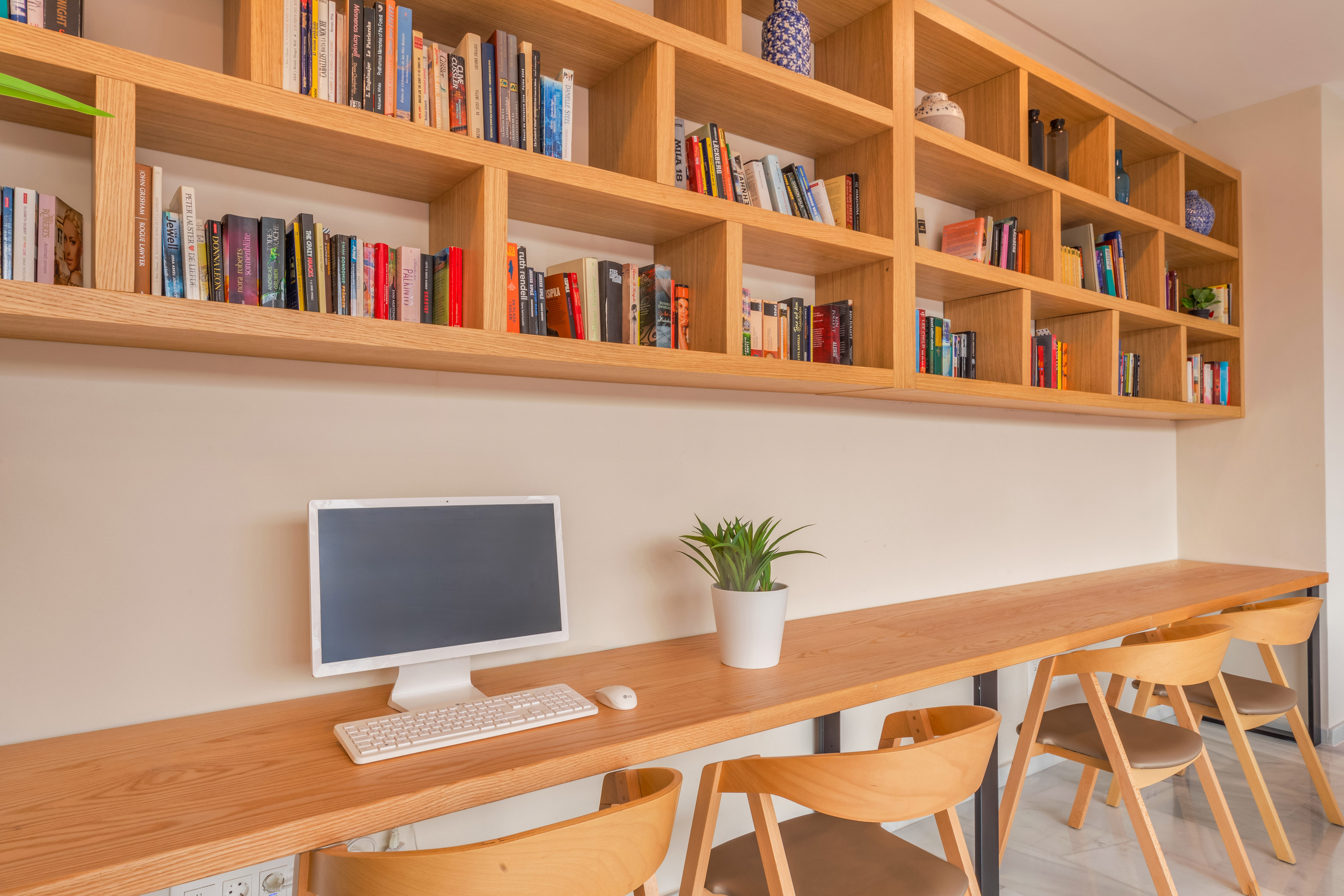 a desk with a computer and books on it
