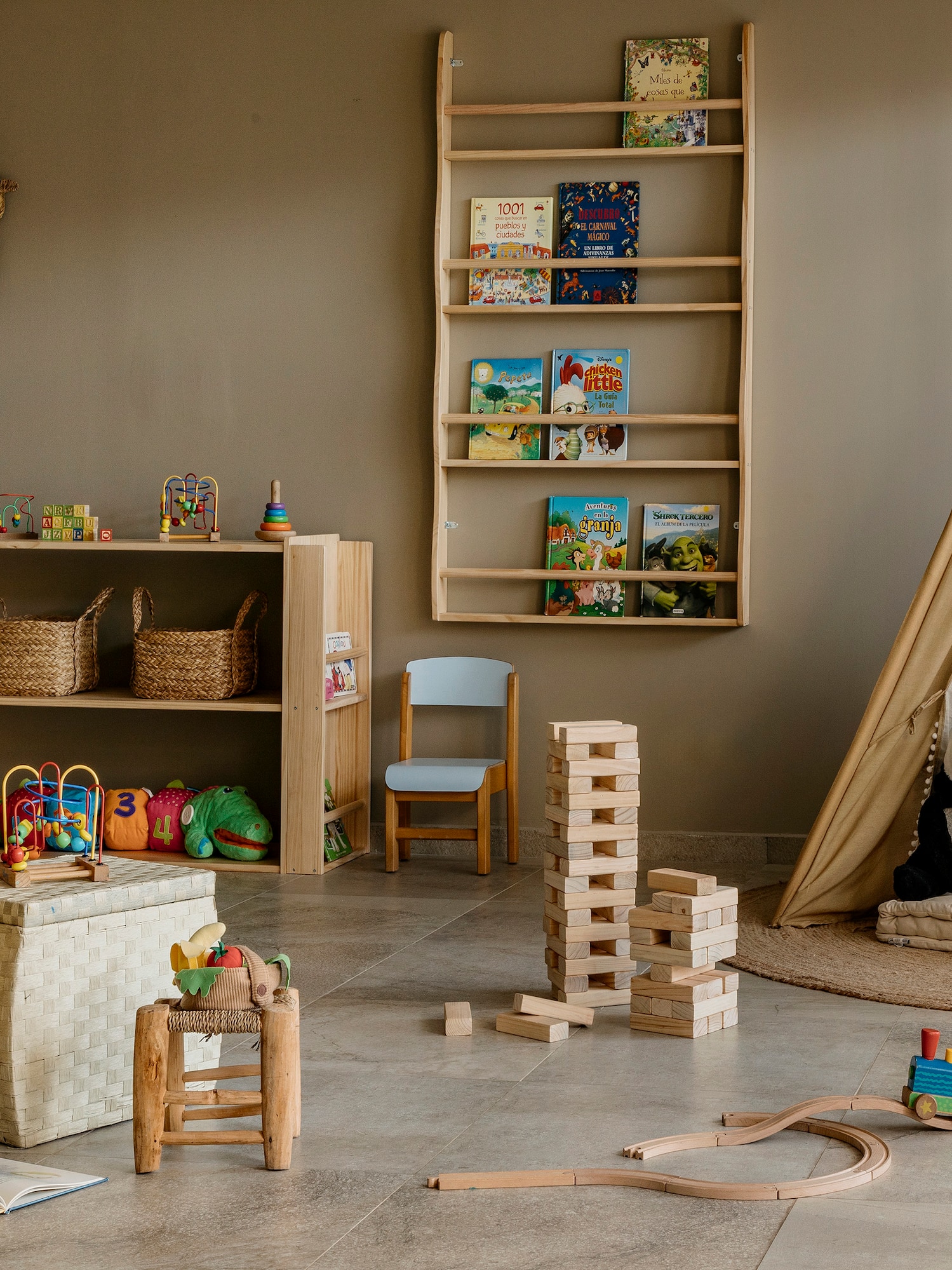 Cozy children's playroom with wooden toys, teepee, books, and natural decor.