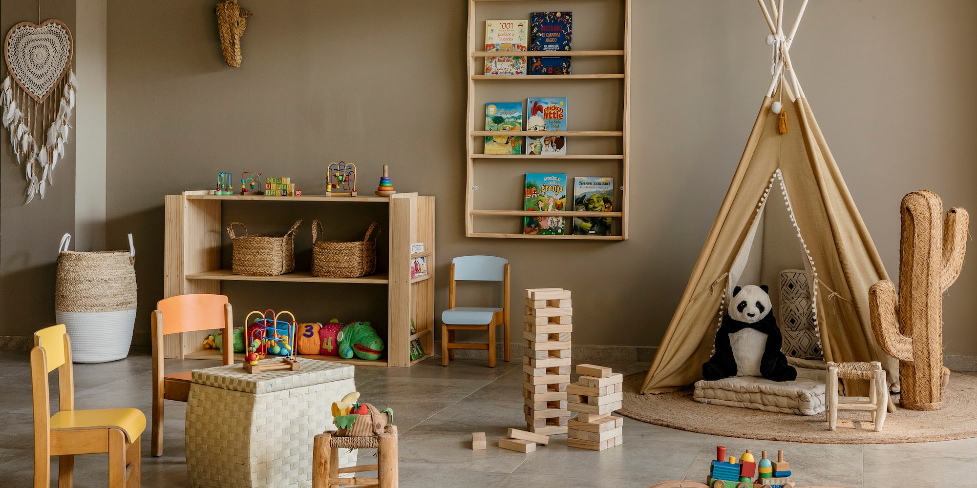 Cozy kids' playroom with wooden toys, books, teepee, and natural decor.