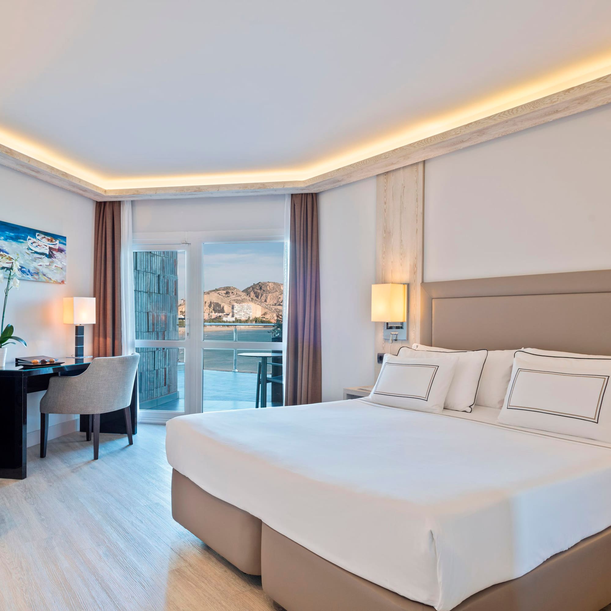 a bedroom with a bed and a desk and chair