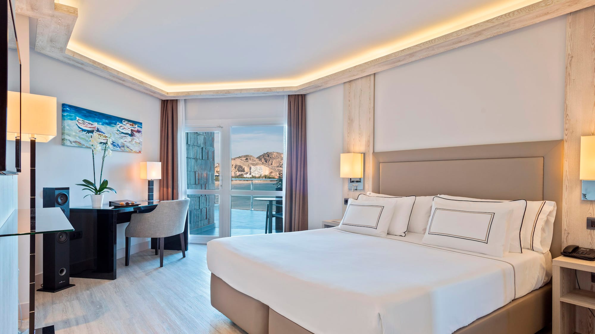 a bedroom with a bed and a desk and chair