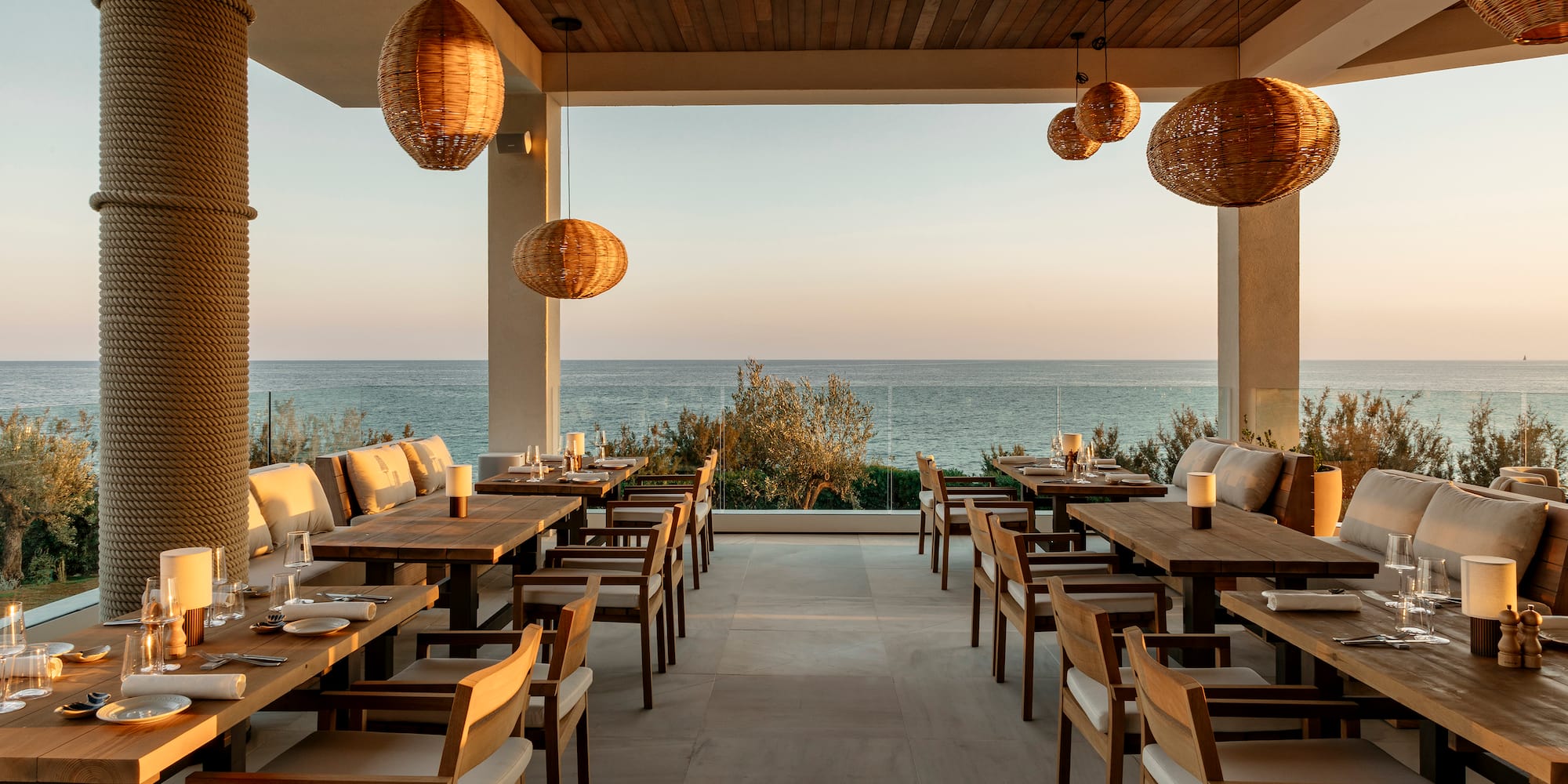 a restaurant with tables and chairs and a view of the ocean