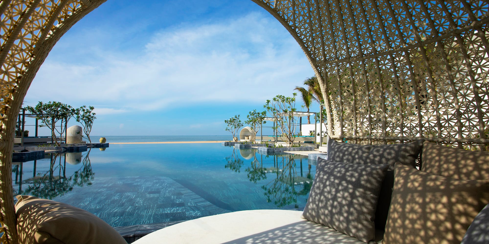 a pool with a large body of water and a white couch