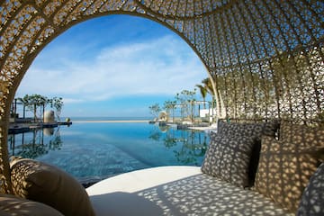 a pool with a large body of water and a white couch
