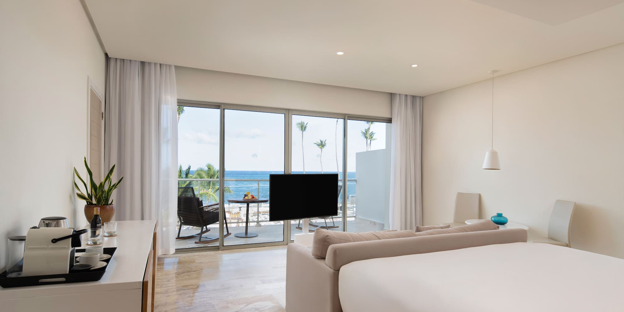 a room with a television and a large window