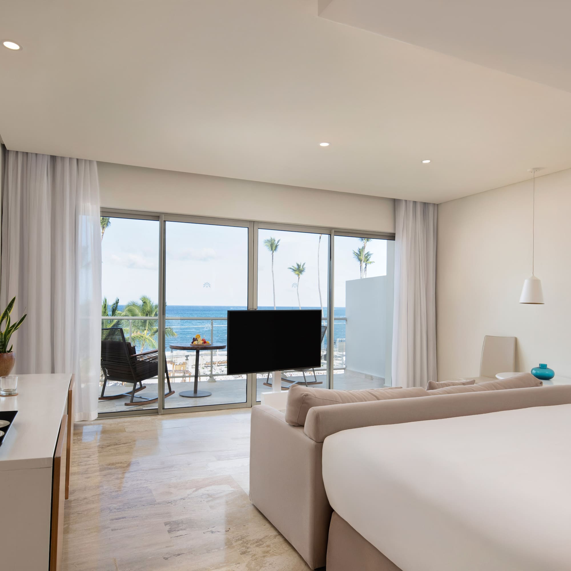 a room with a television and a large window