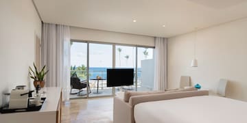 a room with a television and a large window