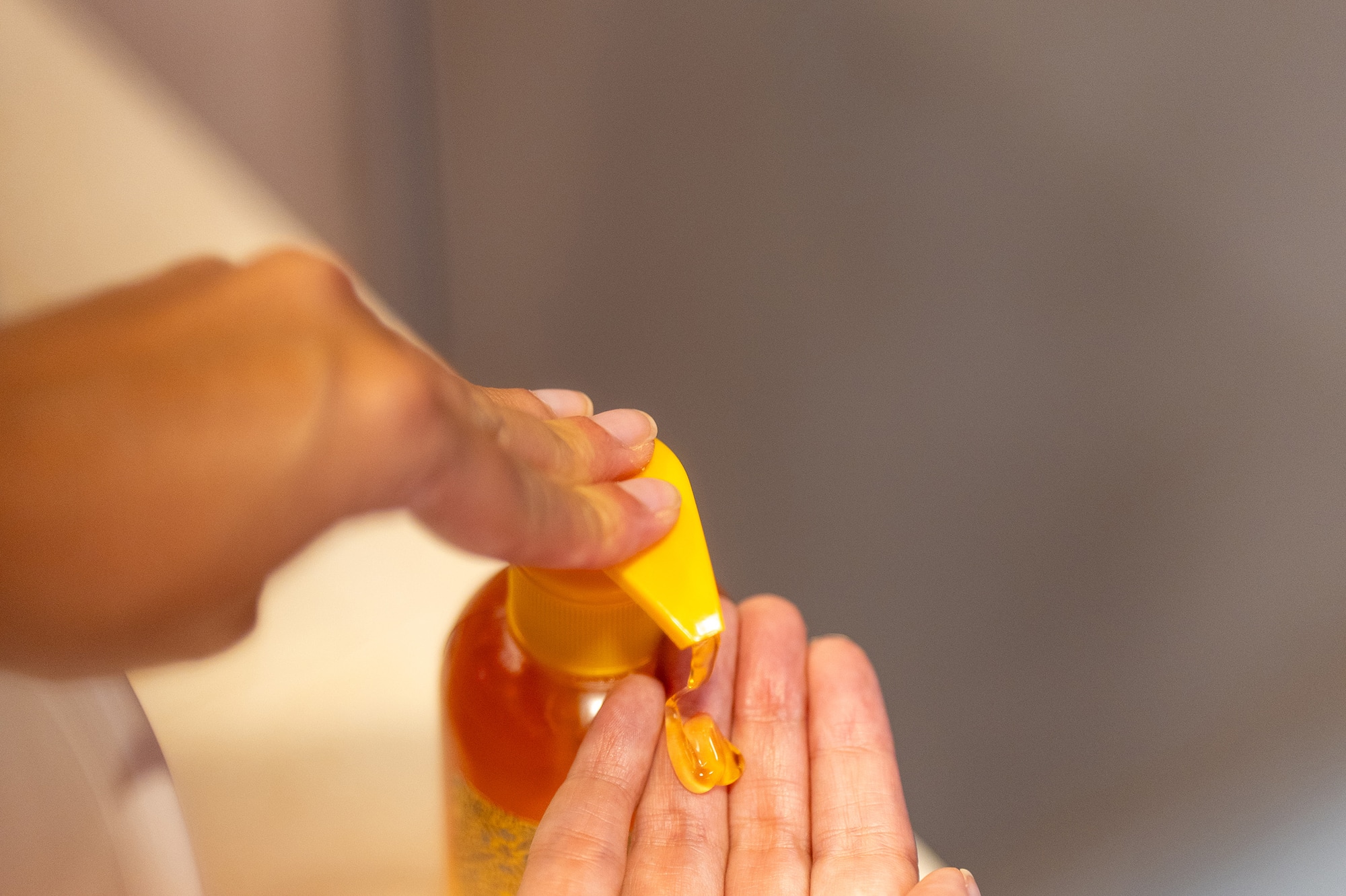 a person pouring liquid onto their hands