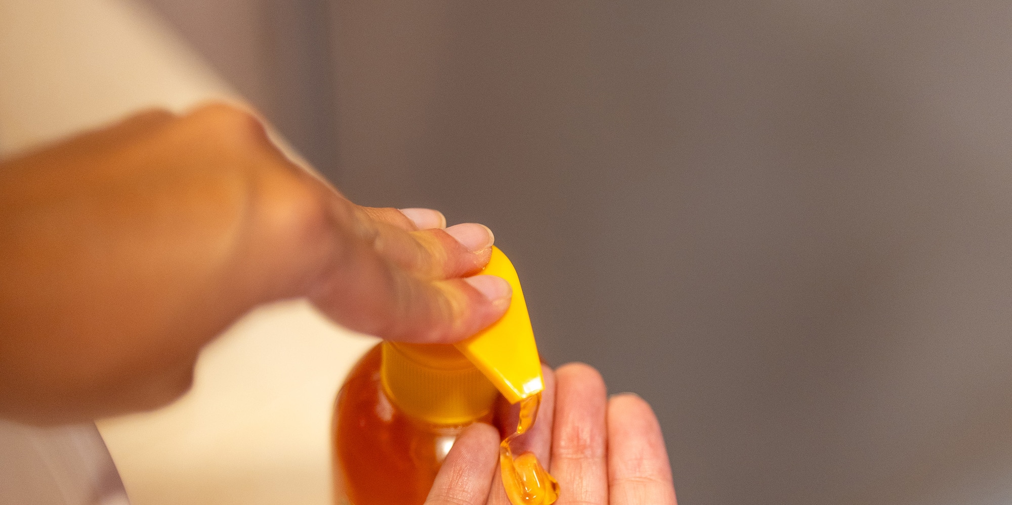 a person pouring liquid onto their hands