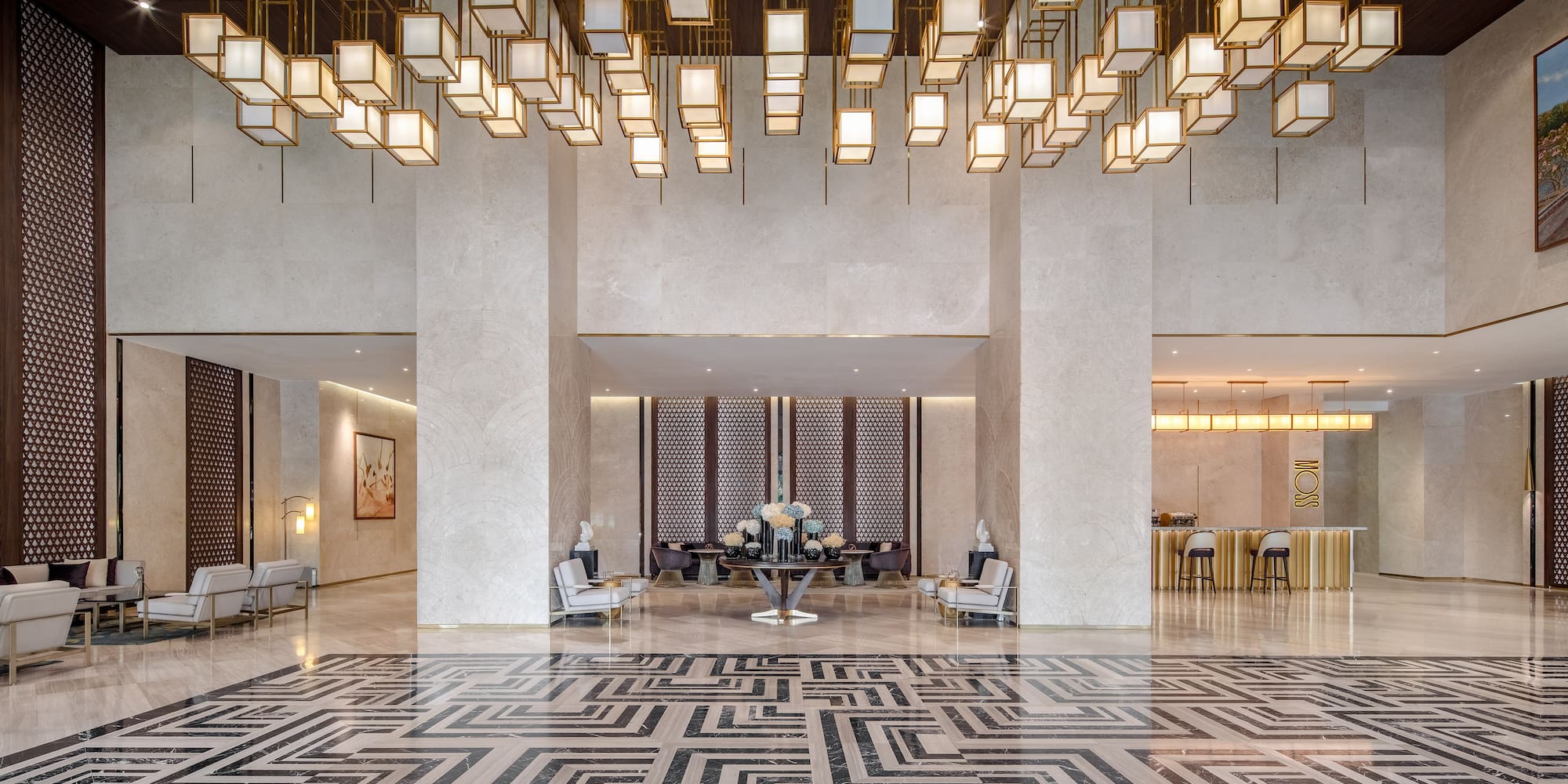 a large lobby with a large chandelier and a table