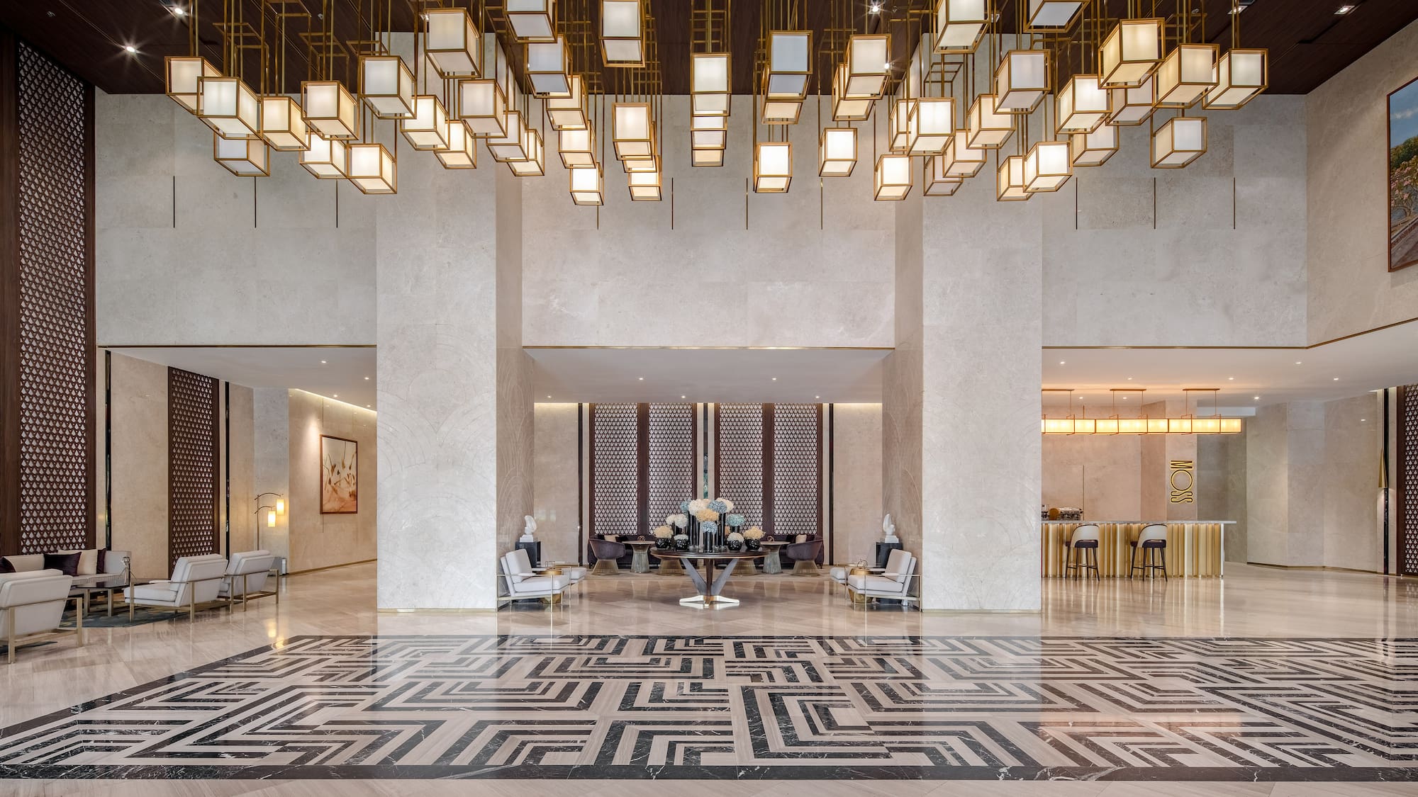 a large lobby with a large chandelier and a table