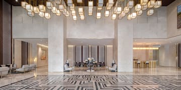 a large lobby with a large chandelier and a table