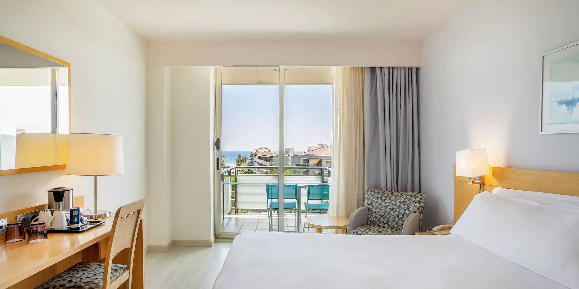 a room with a bed and a desk and chair