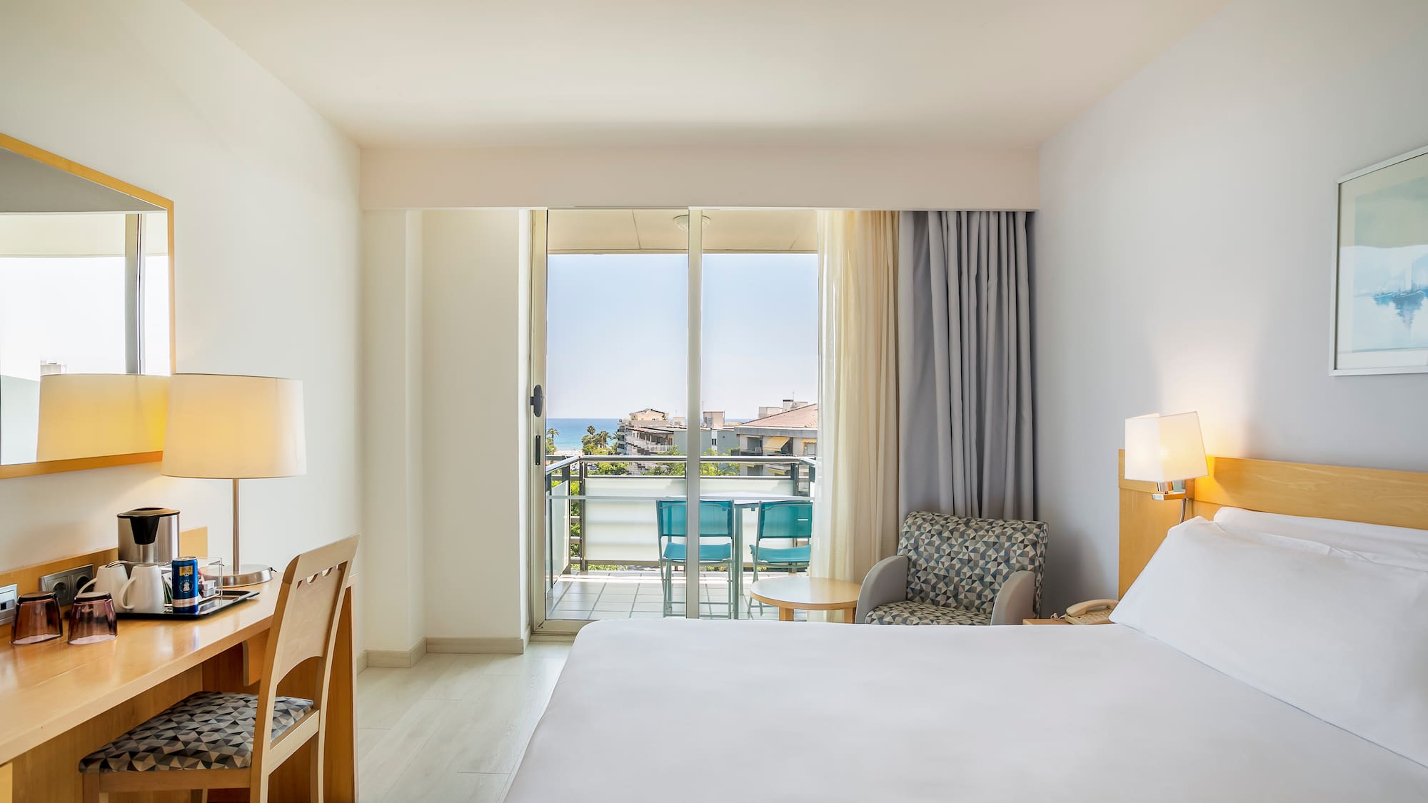 a room with a bed and a desk and chair