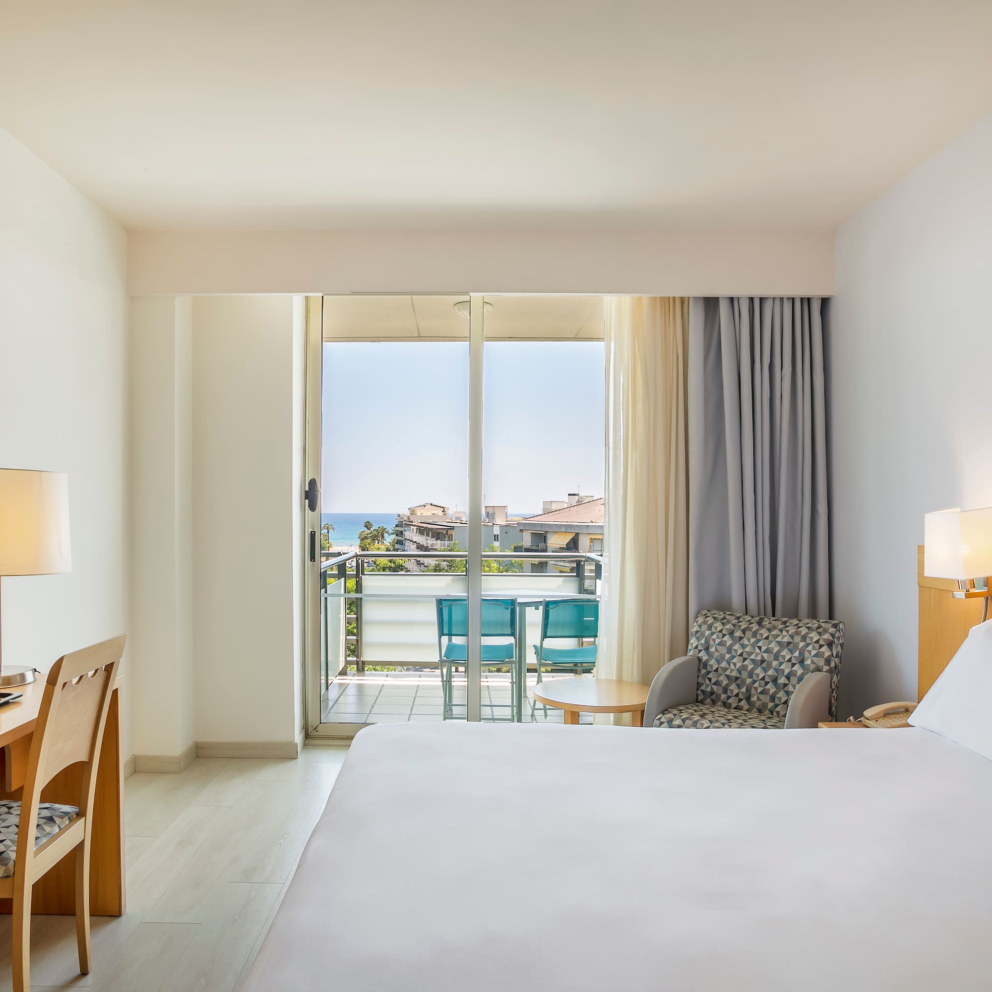 a room with a bed and a desk and chair