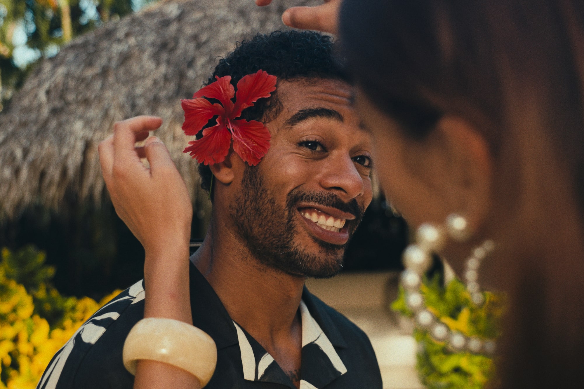 a man with a flower on his ear