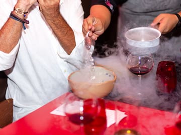 a person pouring liquid into a bowl