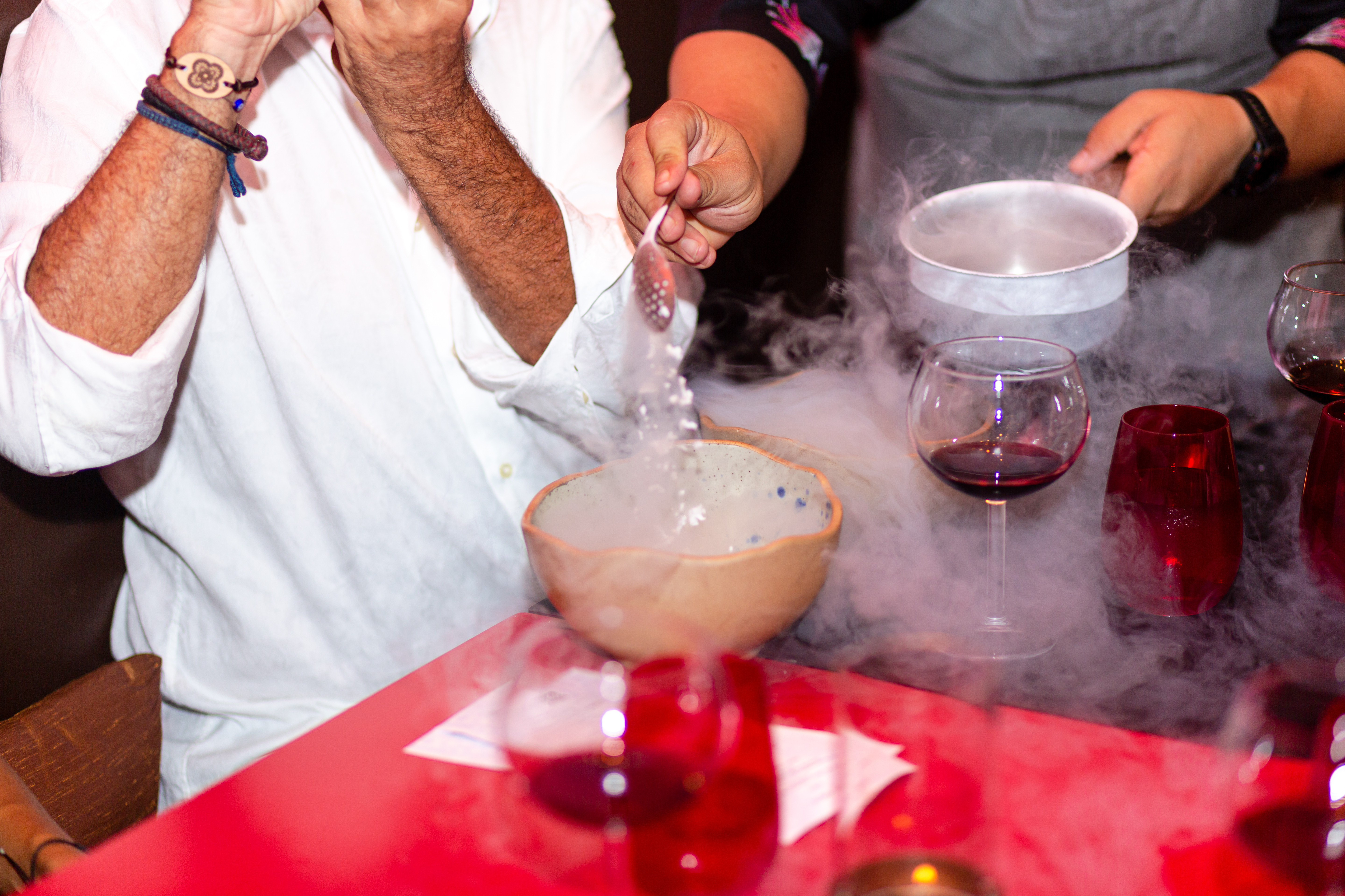 a person pouring liquid into a bowl
