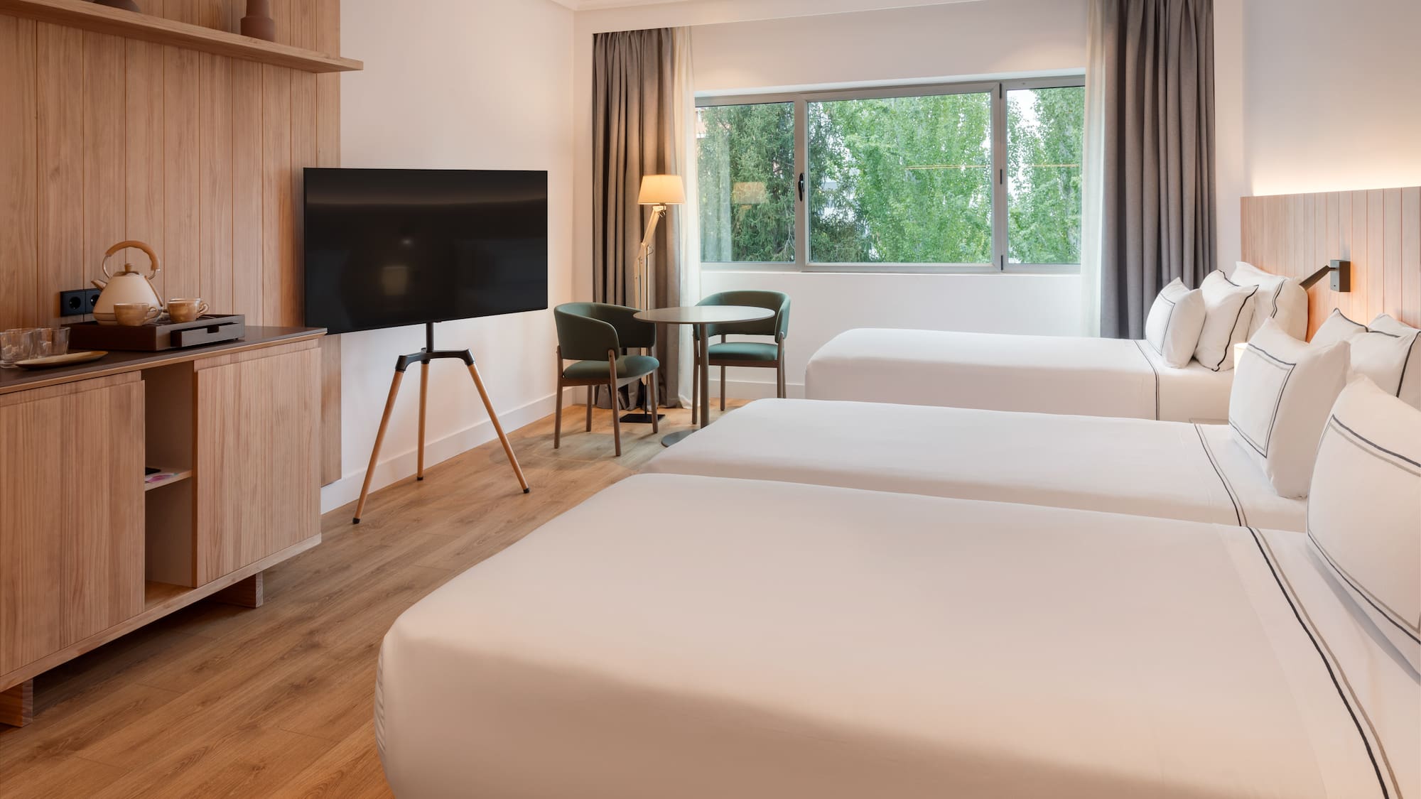 a room with two beds and a television