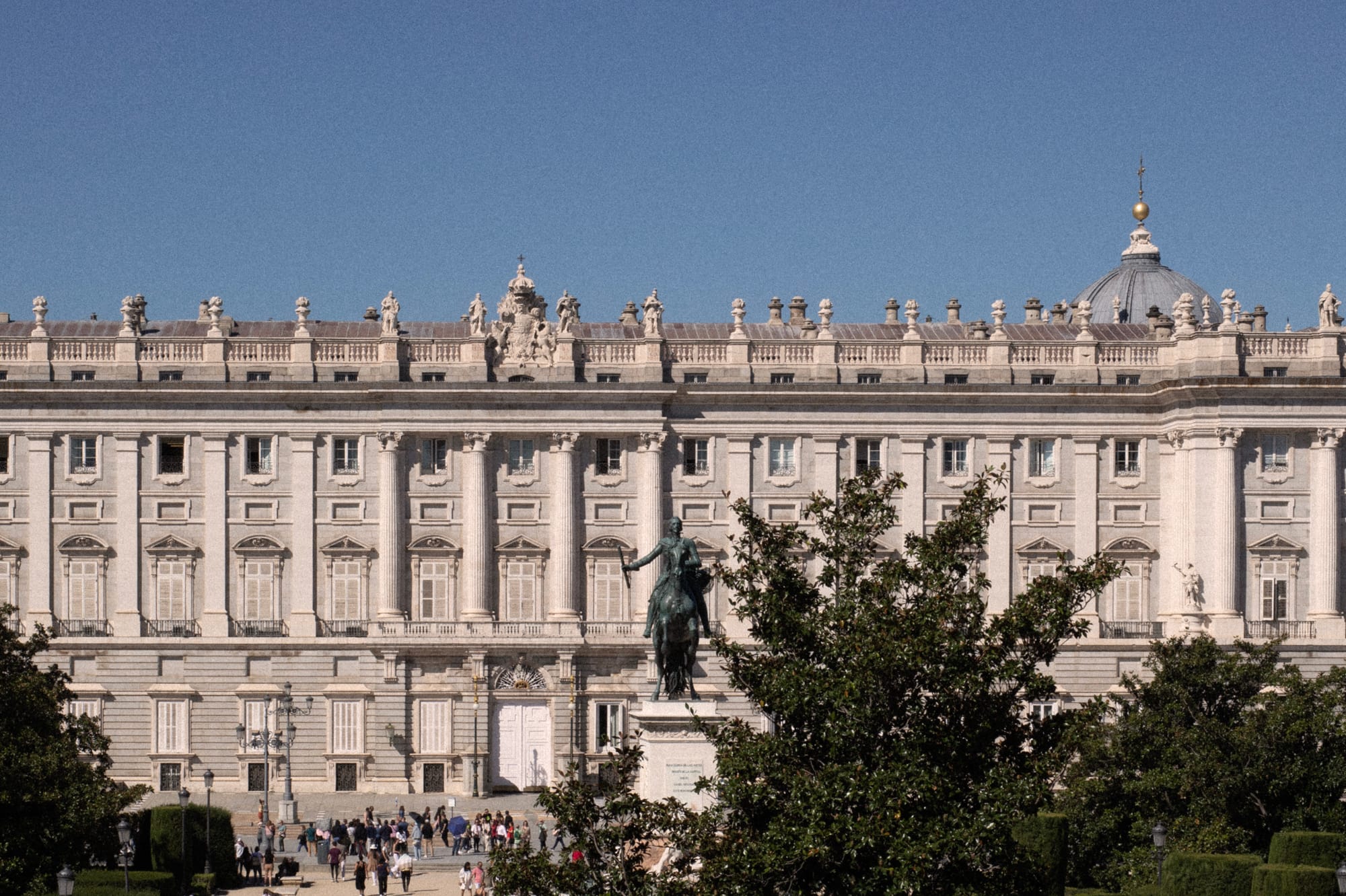 a big white building with a statue in front