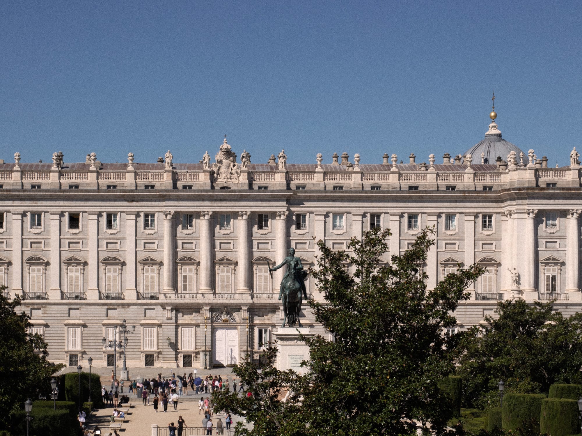 a big white building with a statue in front