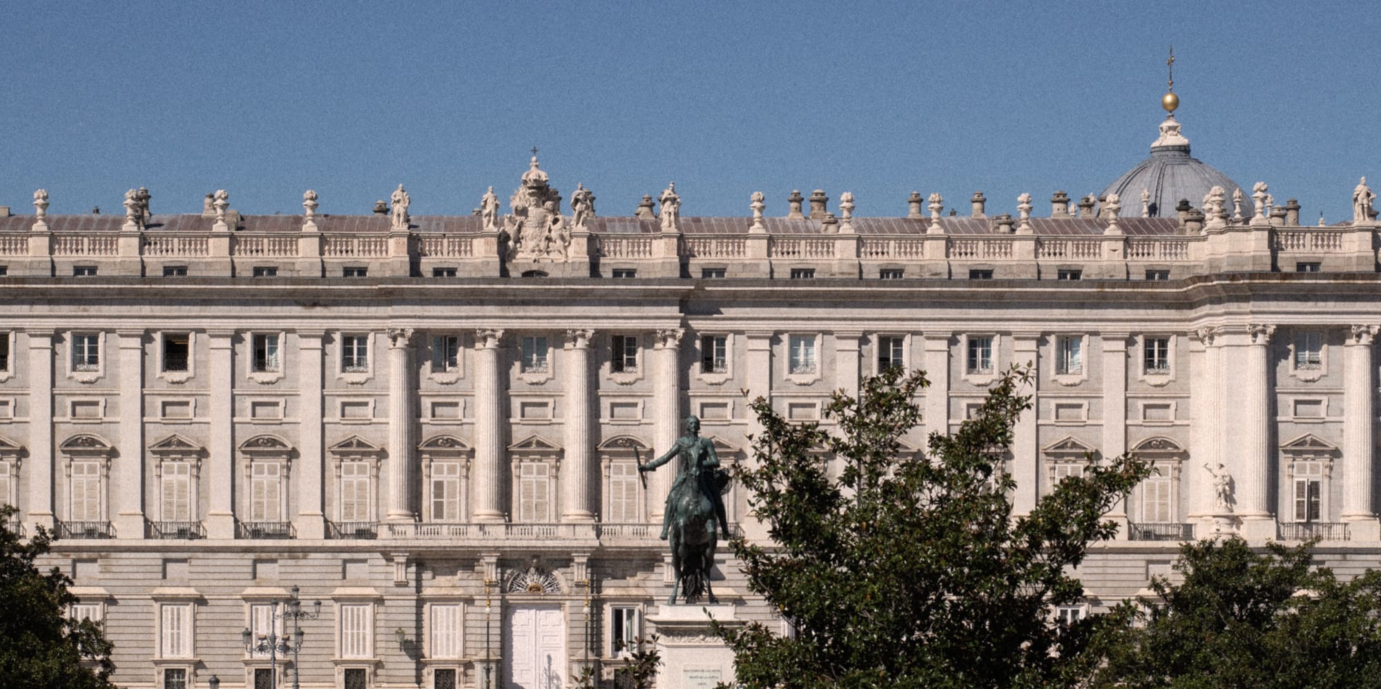 a large white building with a statue in front of it